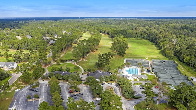 aerial view featuring golf course view and a forest view