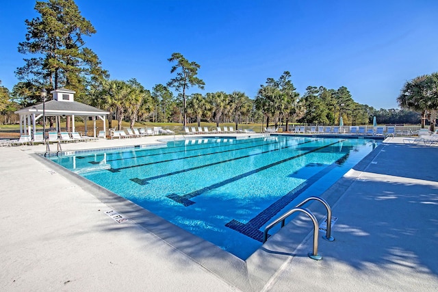 community pool featuring a gazebo and a patio