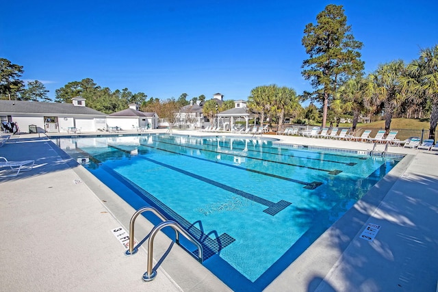pool featuring fence and a patio area