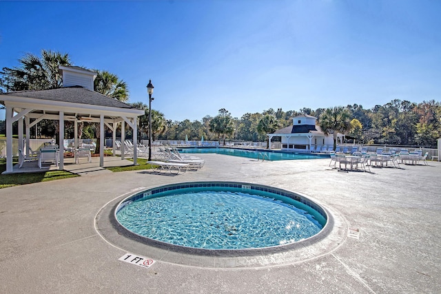 pool featuring fence, a gazebo, and a patio