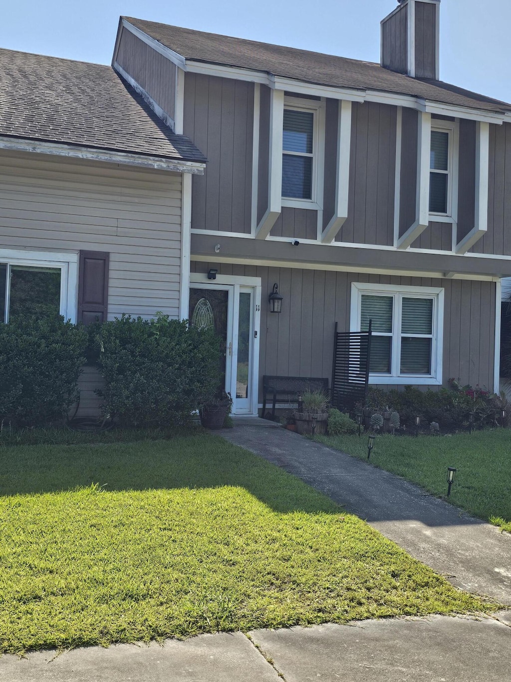 11 Hunters Ct, Goose Creek, SC 29445 - view of front of house featuring a front yard, a chimney, and a shingled roof