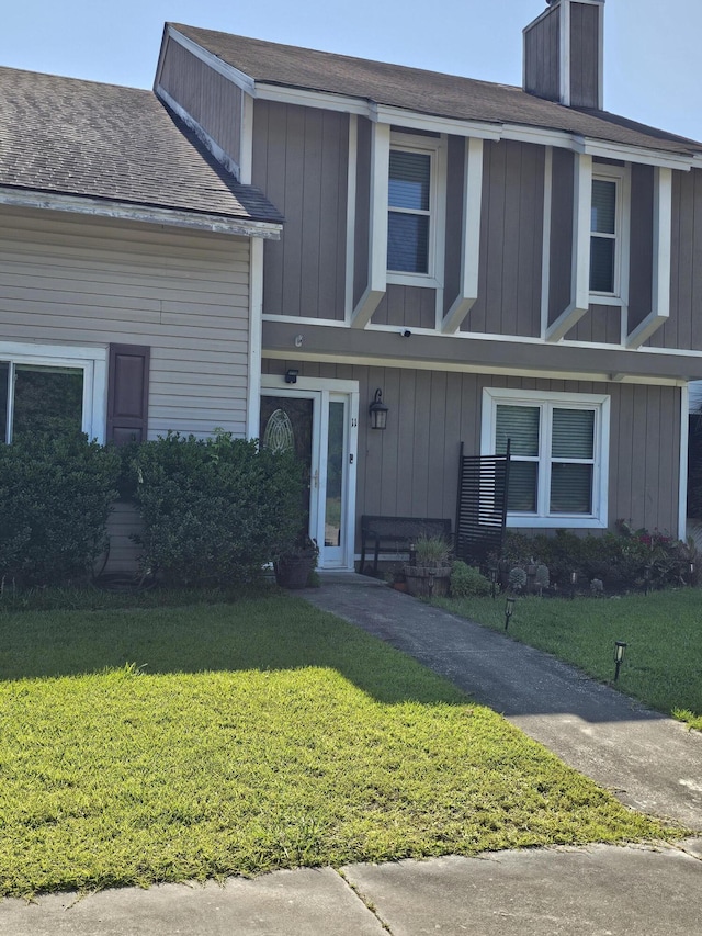11 Hunters Ct, Goose Creek, SC 29445 - view of front of house featuring a front yard, a chimney, and a shingled roof