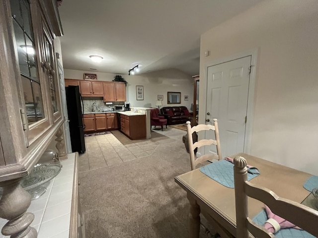 carpeted dining room with sink