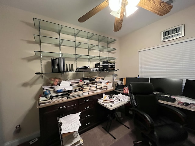 carpeted home office featuring ceiling fan