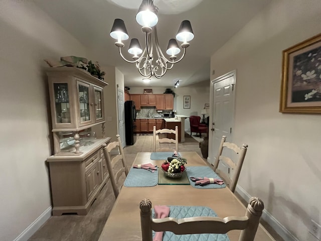 dining space with an inviting chandelier