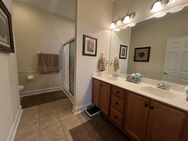 bathroom with vanity, tile patterned floors, and a shower with door