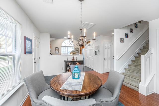 dining room featuring an inviting chandelier and dark hardwood / wood-style flooring