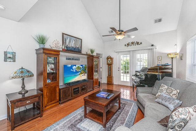 living room with ceiling fan, french doors, hardwood / wood-style floors, and high vaulted ceiling