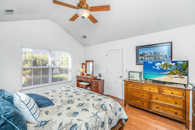 bedroom featuring lofted ceiling, light hardwood / wood-style floors, and ceiling fan