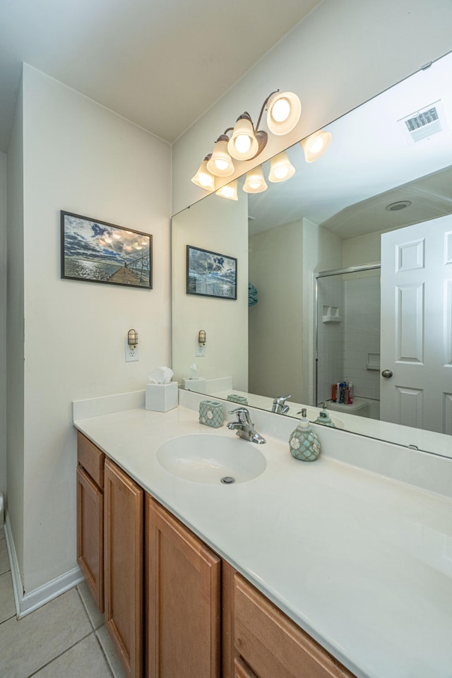 bathroom featuring vanity, tile patterned flooring, and an enclosed shower