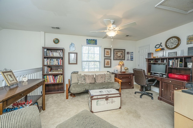 carpeted home office with ceiling fan