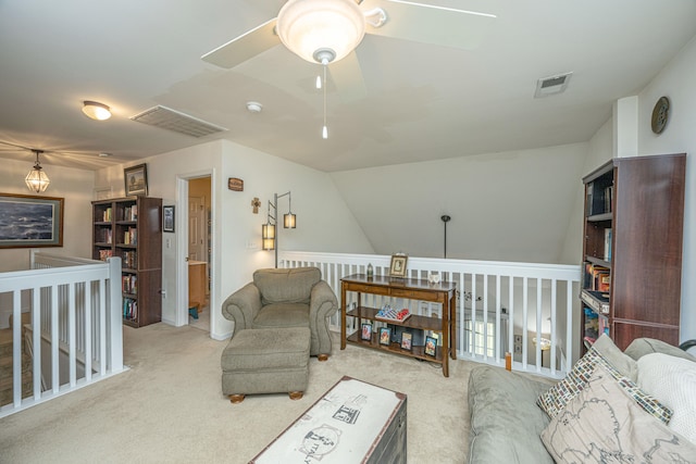 living room with lofted ceiling, ceiling fan, and carpet