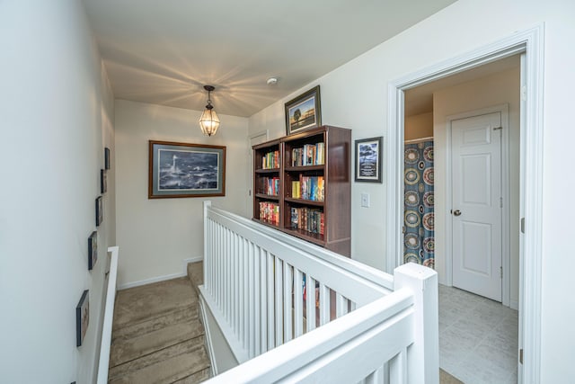 corridor featuring light colored carpet