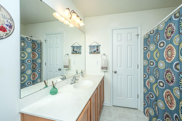 bathroom with tile patterned floors and vanity