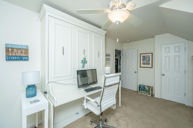 carpeted home office with lofted ceiling and ceiling fan