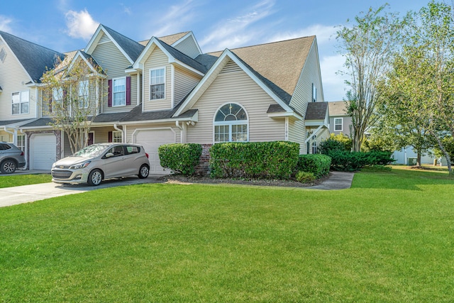 view of front of house with a front yard and a garage