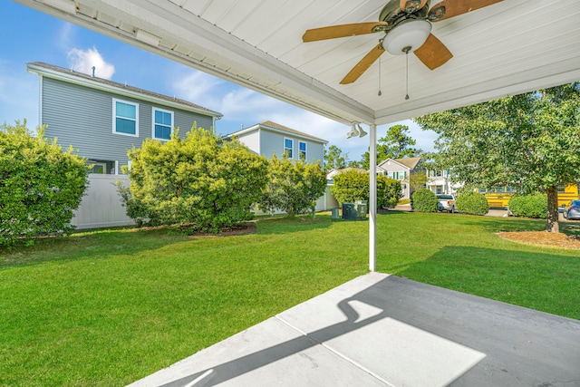 view of yard with ceiling fan and a patio area