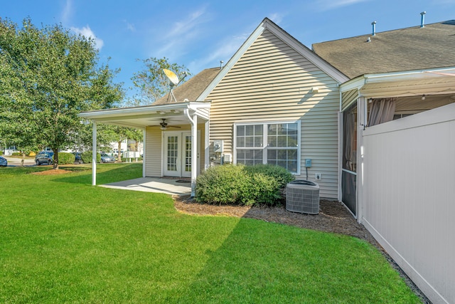 rear view of property with ceiling fan, french doors, central AC unit, a patio area, and a yard