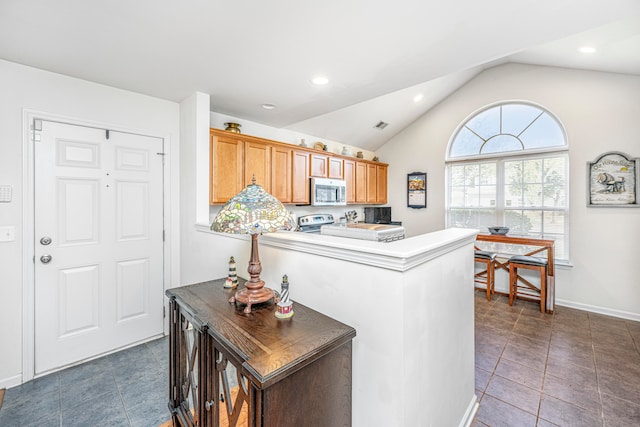 kitchen with dark tile patterned flooring and vaulted ceiling