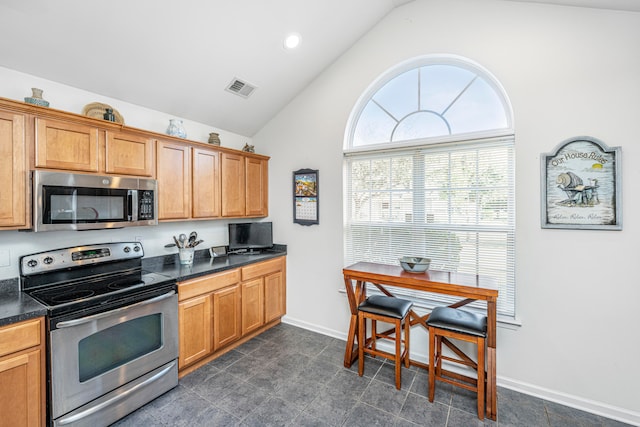 kitchen featuring appliances with stainless steel finishes and high vaulted ceiling