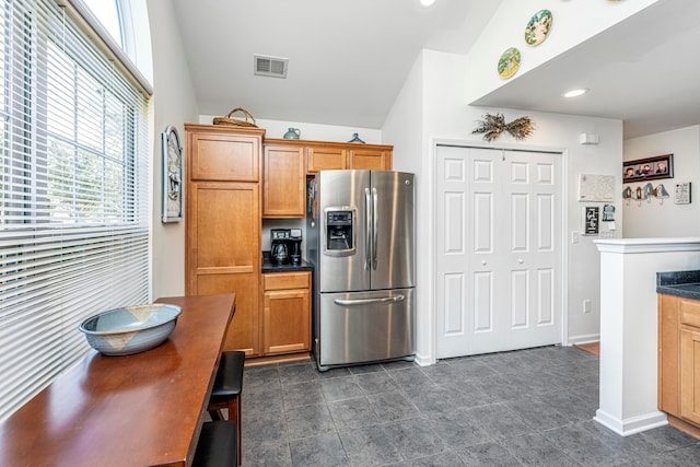 kitchen with lofted ceiling and stainless steel fridge