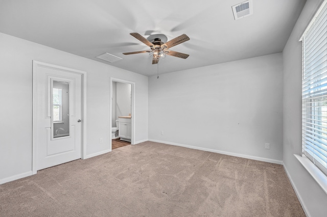 unfurnished bedroom featuring connected bathroom, ceiling fan, and carpet