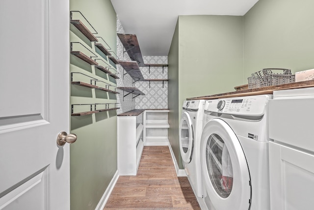 laundry room with wood-type flooring and washing machine and clothes dryer