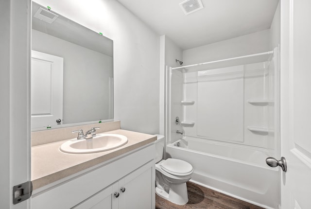 full bathroom featuring bathing tub / shower combination, hardwood / wood-style floors, vanity, and toilet