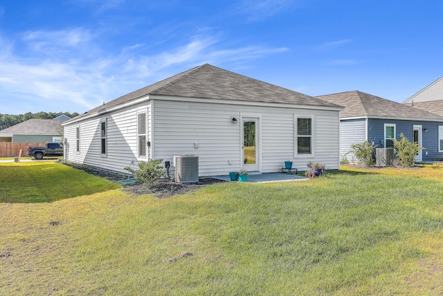 rear view of house with central AC, a yard, and a patio