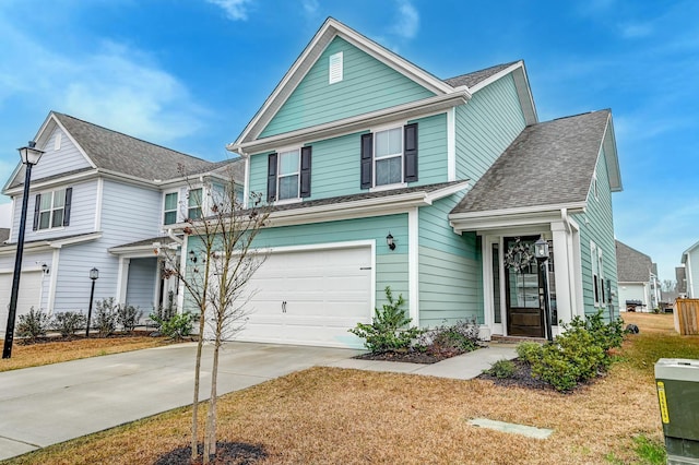 view of front of house featuring a garage, concrete driveway, and a shingled roof