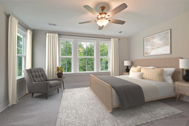 carpeted bedroom featuring multiple windows and ceiling fan