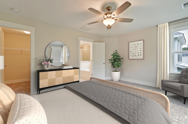 carpeted bedroom with a spacious closet, a closet, ceiling fan, and ensuite bathroom