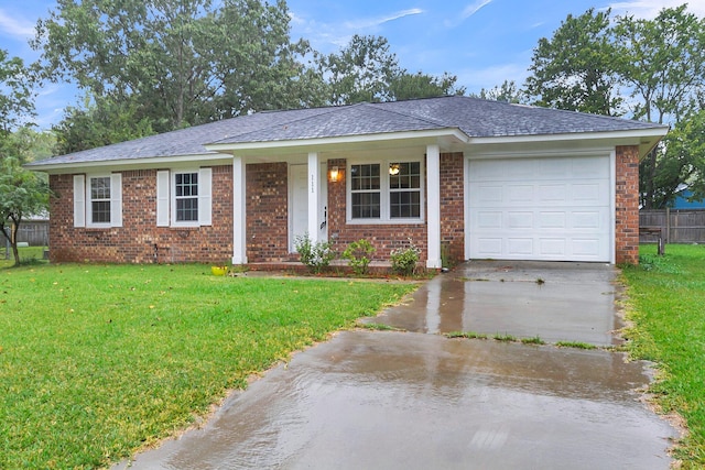 ranch-style home with a garage and a front lawn