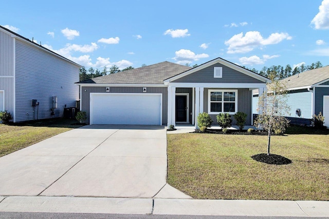 view of front of house with a garage and a front lawn