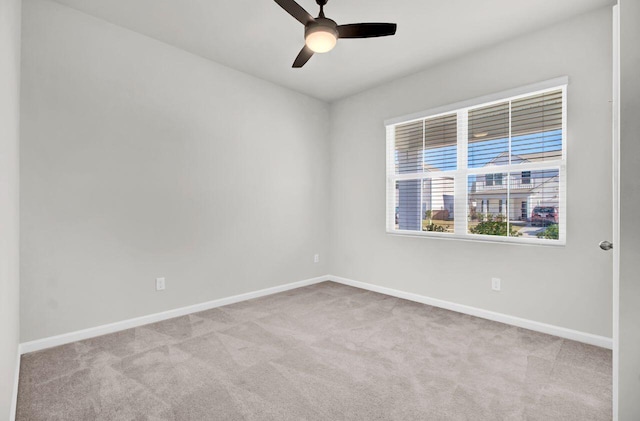 empty room featuring light carpet and ceiling fan