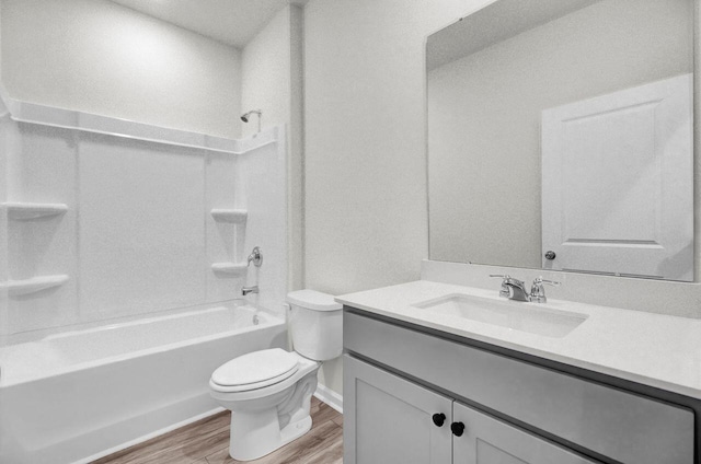 full bathroom with hardwood / wood-style floors, vanity, toilet, and shower / bath combination