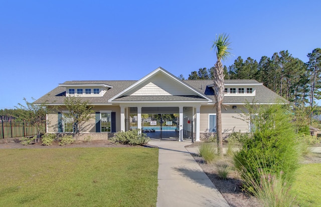 view of front of property with a carport and a front lawn