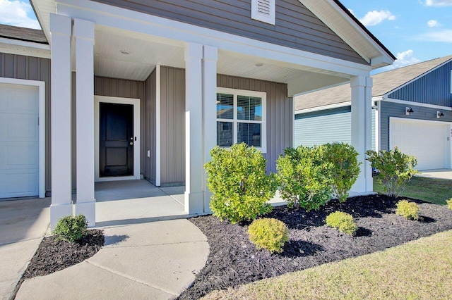 property entrance with a porch and a garage