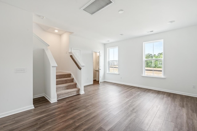 unfurnished living room with dark hardwood / wood-style flooring