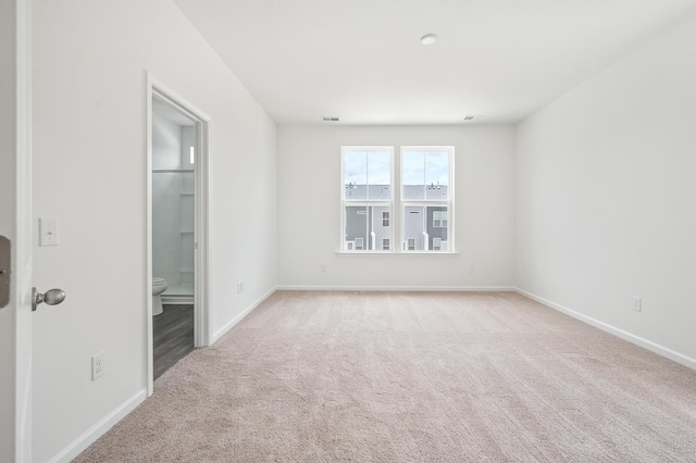 spare room with light colored carpet