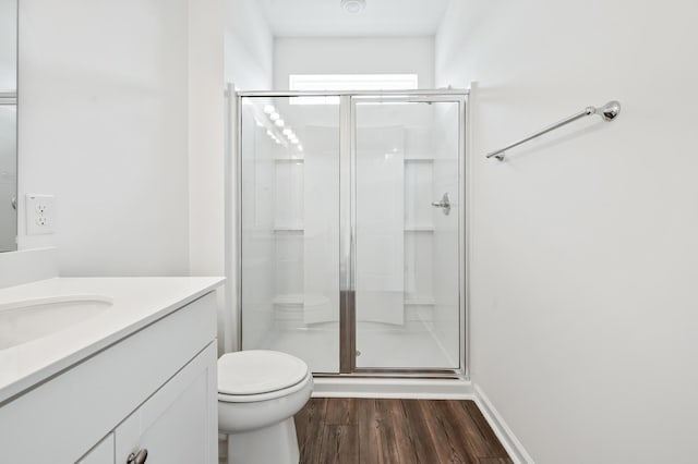 bathroom with vanity, hardwood / wood-style flooring, toilet, and walk in shower