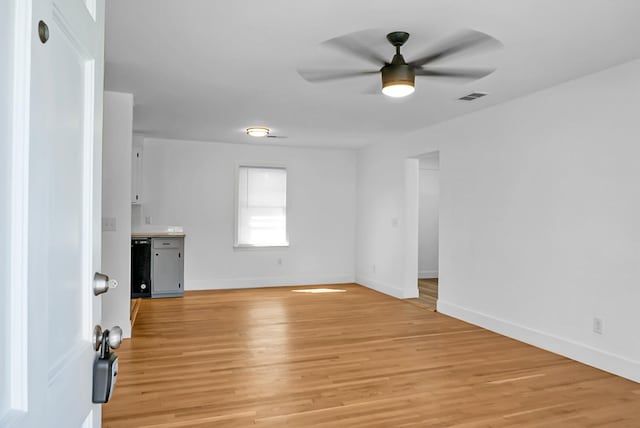 unfurnished room with ceiling fan and light wood-type flooring