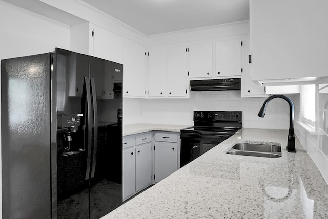 kitchen featuring backsplash, black appliances, sink, and white cabinets