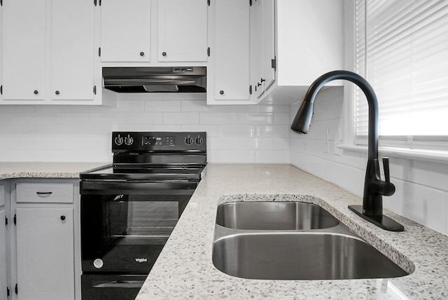 kitchen featuring sink, black stove, plenty of natural light, white cabinetry, and range hood