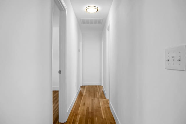 hallway with wood-type flooring