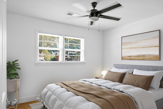 bedroom featuring hardwood / wood-style flooring and ceiling fan