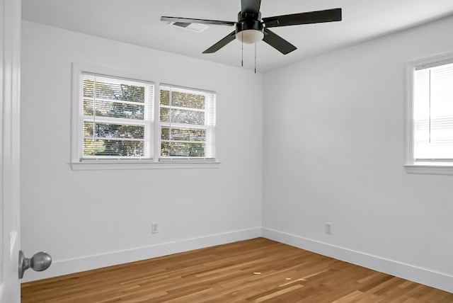 empty room with hardwood / wood-style flooring and ceiling fan