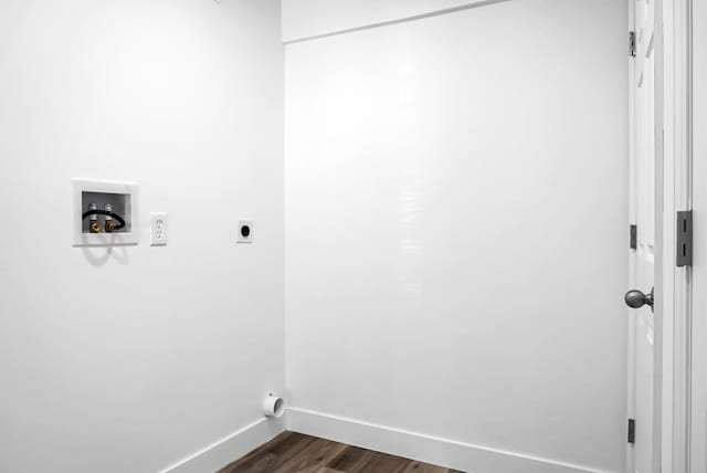 washroom with dark wood-type flooring, hookup for an electric dryer, and hookup for a washing machine