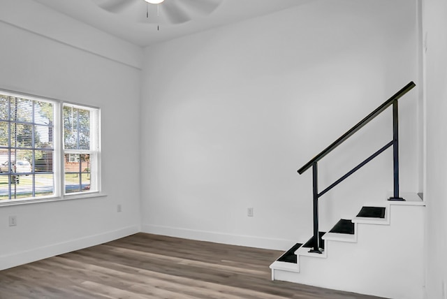 empty room with hardwood / wood-style floors and ceiling fan