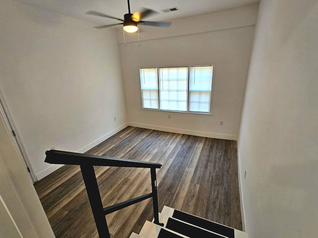 empty room with dark hardwood / wood-style floors and ceiling fan